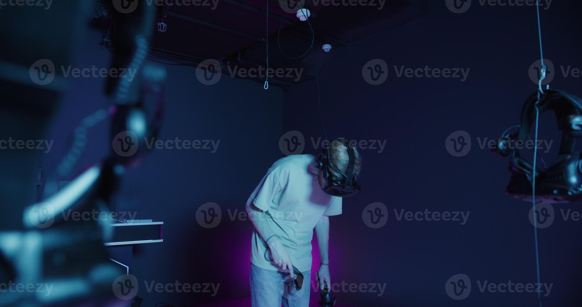 A man in a dark room with headphones on photo