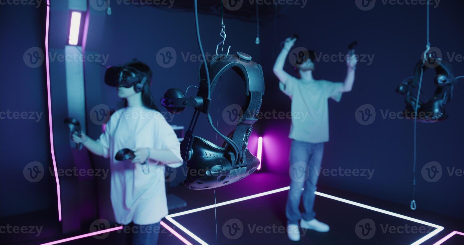 Two people in a room with a purple light photo