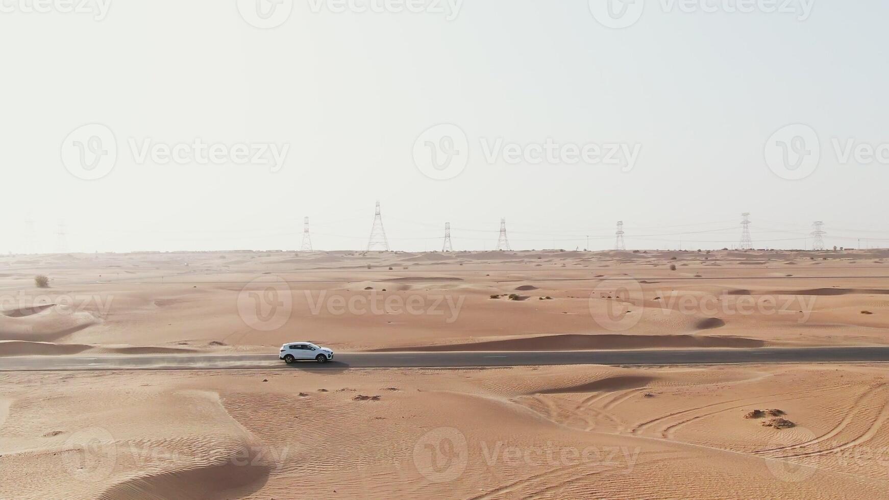 A white car driving through the desert photo