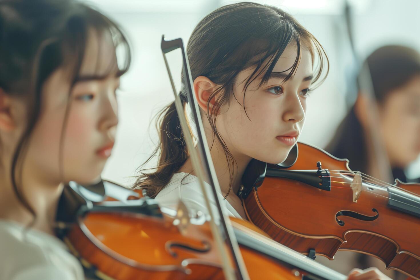 Young asian women playing violin in a group photo