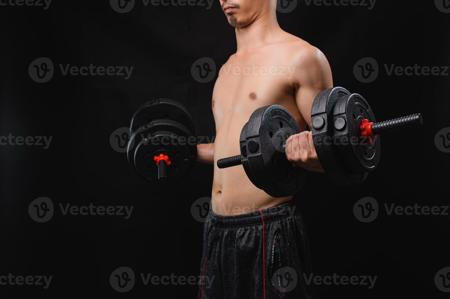 Young Man Lifting Dumbbells for Strength and Health Enhancement photo