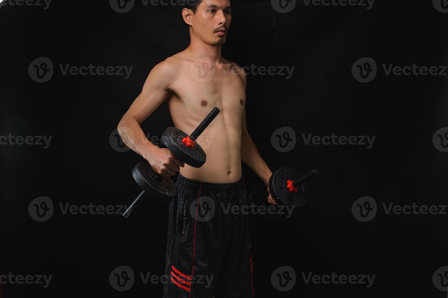 Strong Man Lifting Dumbbells for Building Muscle and Strength photo