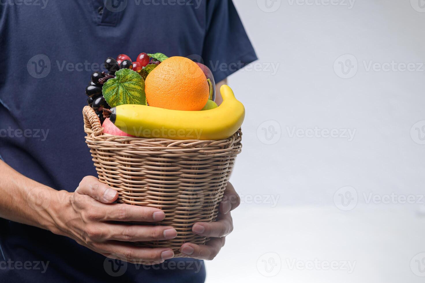 Fresh and Colorful Fruit Basket Held by a Person's Hands photo