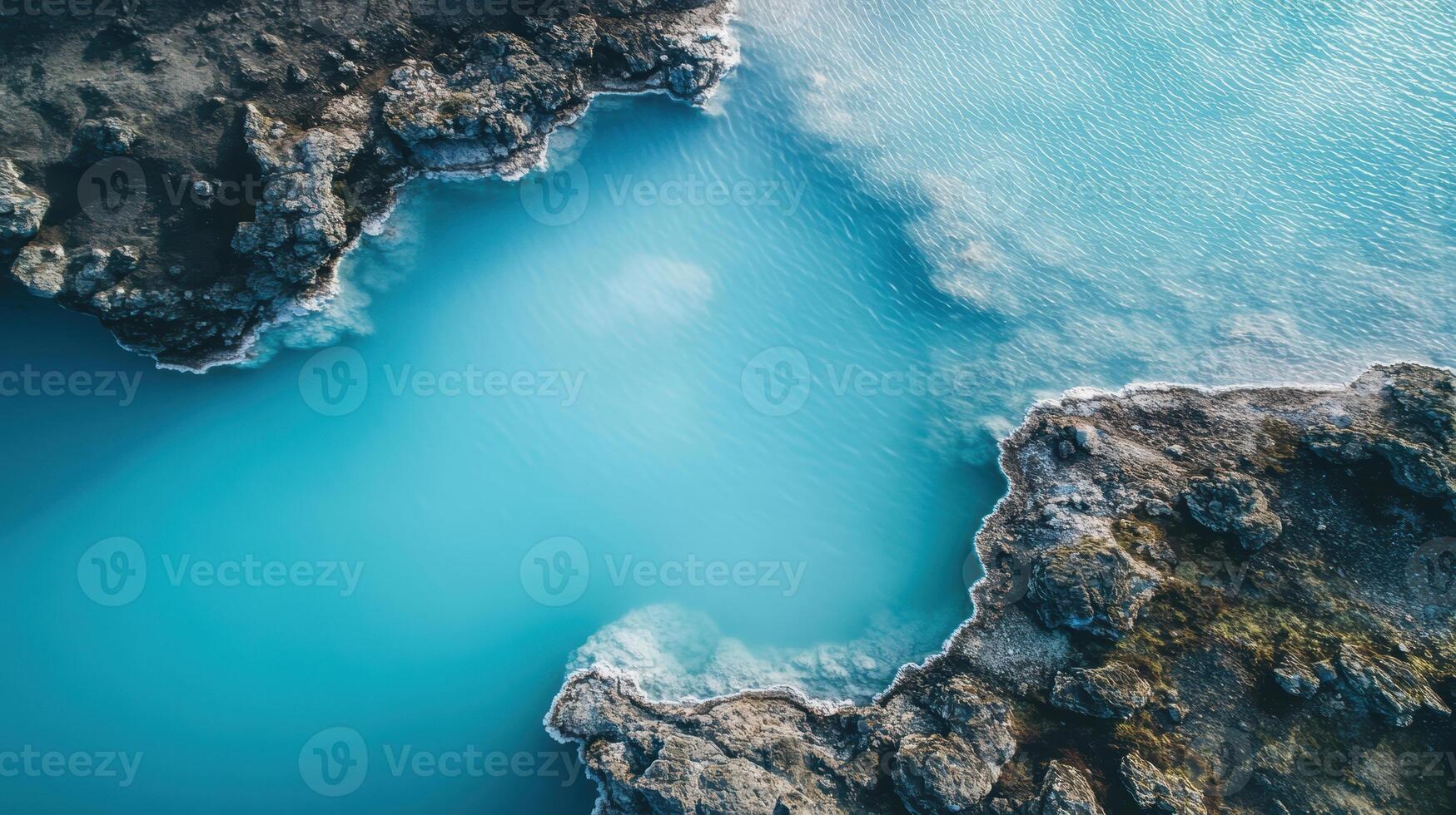 Aerial view of vibrant turquoise sea water and rugged rock formations. photo