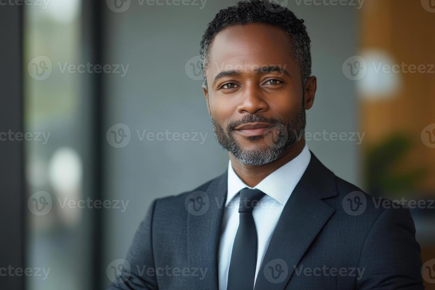 Confident african American man, male adult in business attire smiling indoors. photo