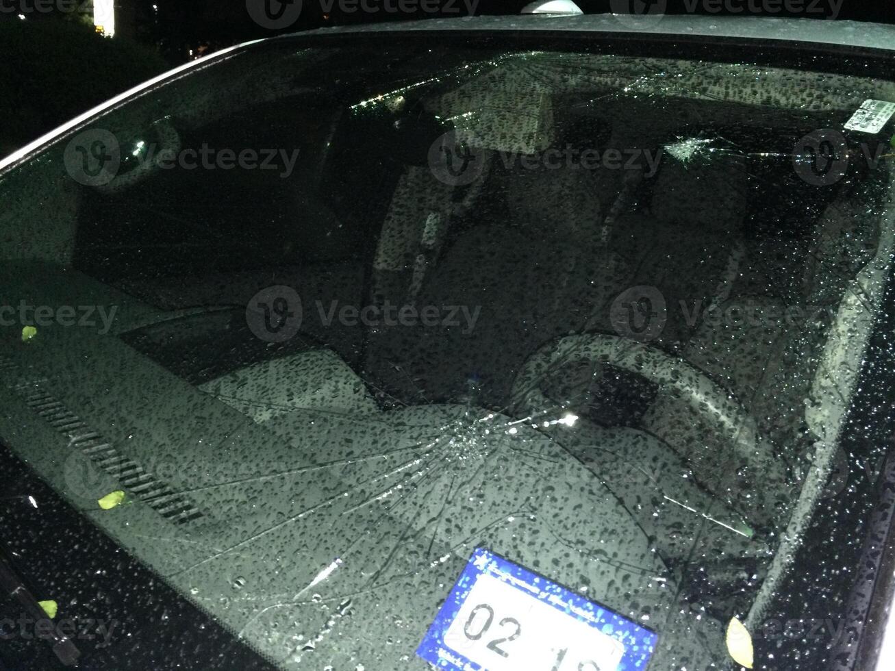 Hail Damage to Car, Broken Cracked Windshield photo