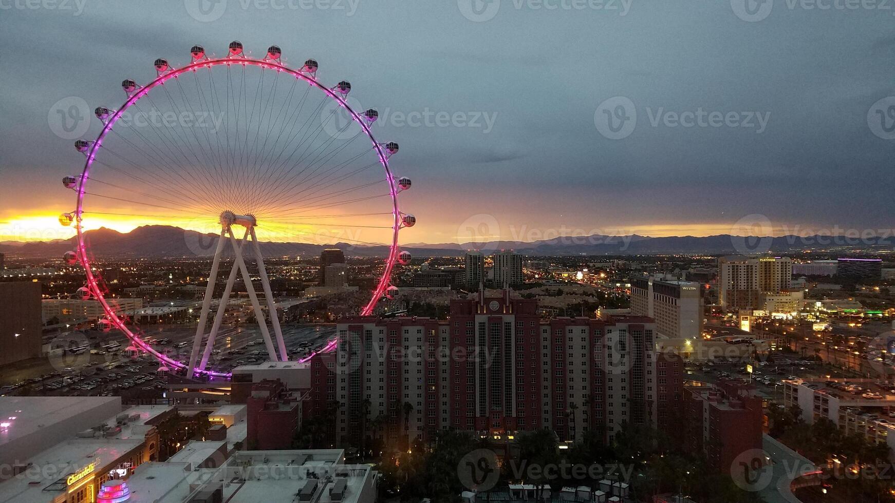 Las Vegas Strip at Sunset, Giant Wheel Lit Up Pink and Purple photo