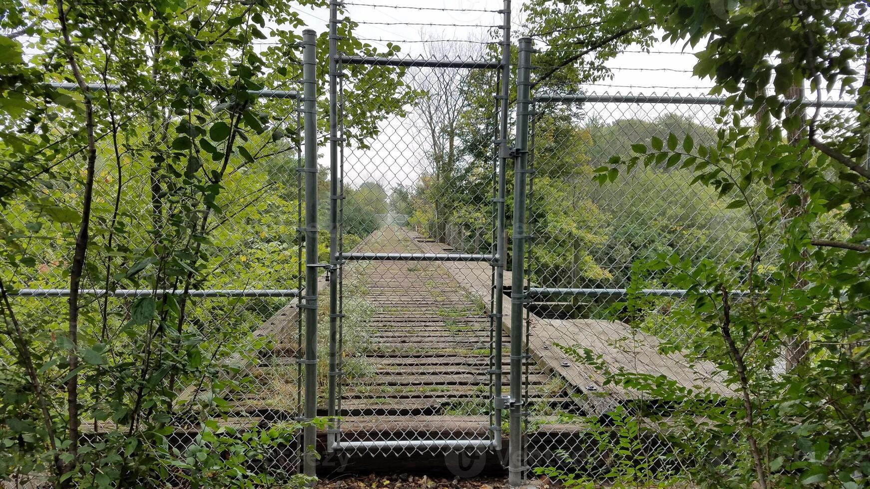 Abandoned Train Trestle in Burlington, Wisconsin with Chain Link Fence photo
