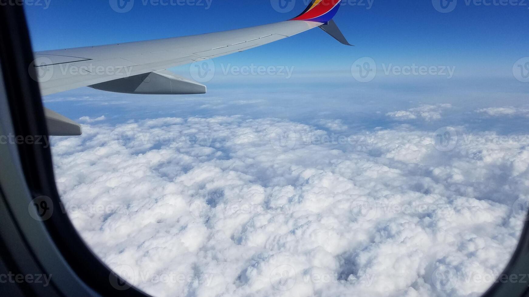 Flying above Puffy Clouds, View from the Plane Window photo
