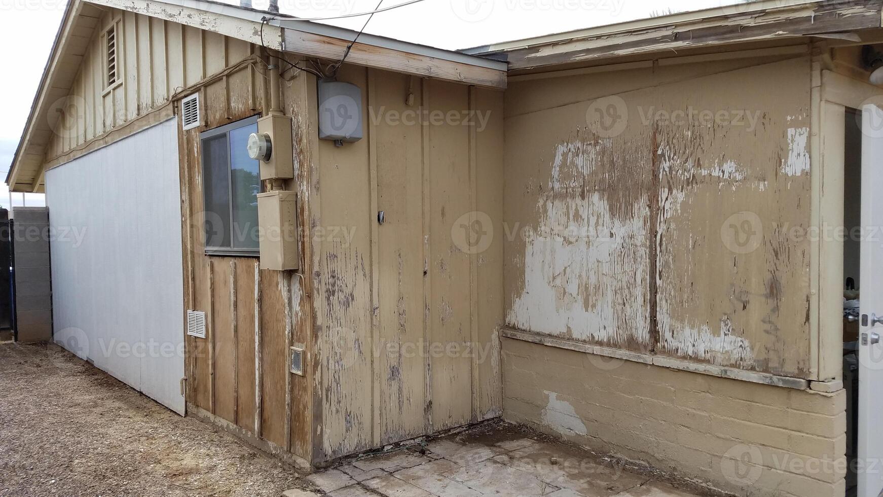 Exterior of a Fixer Upper House, Run Down Property Remodel, Peeling Paint photo