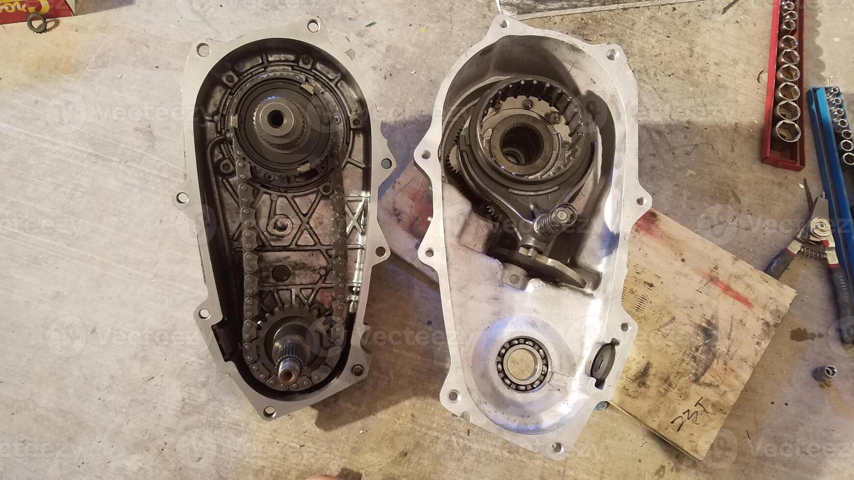 Two Halves of a Transfer Case from 1990s SUV Opened Up to Work On and Repair photo