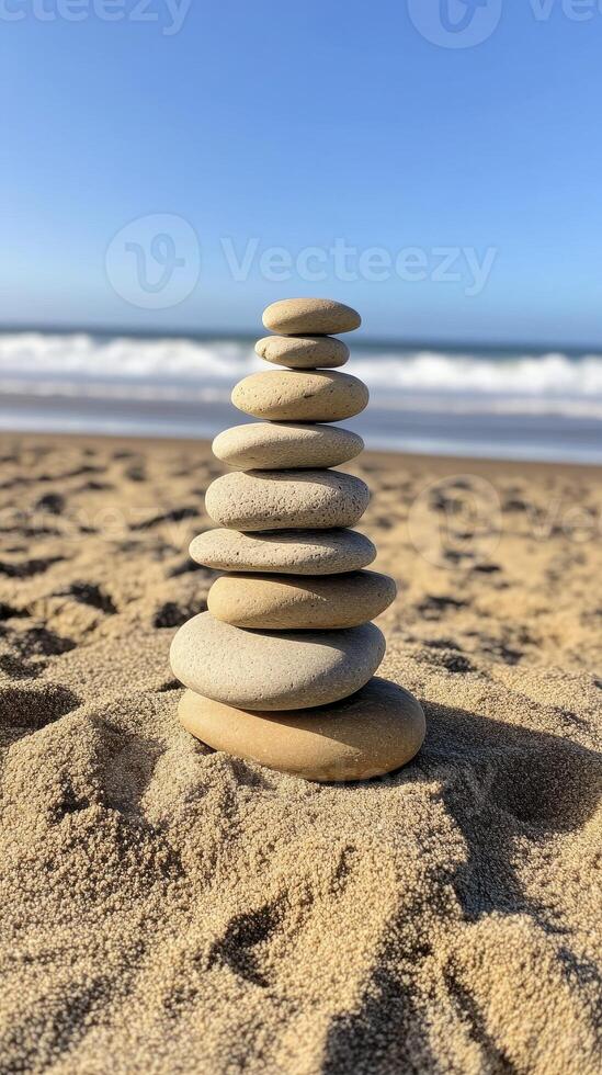 Balanced Stones Stack on Sandy Beach Ocean Background photo