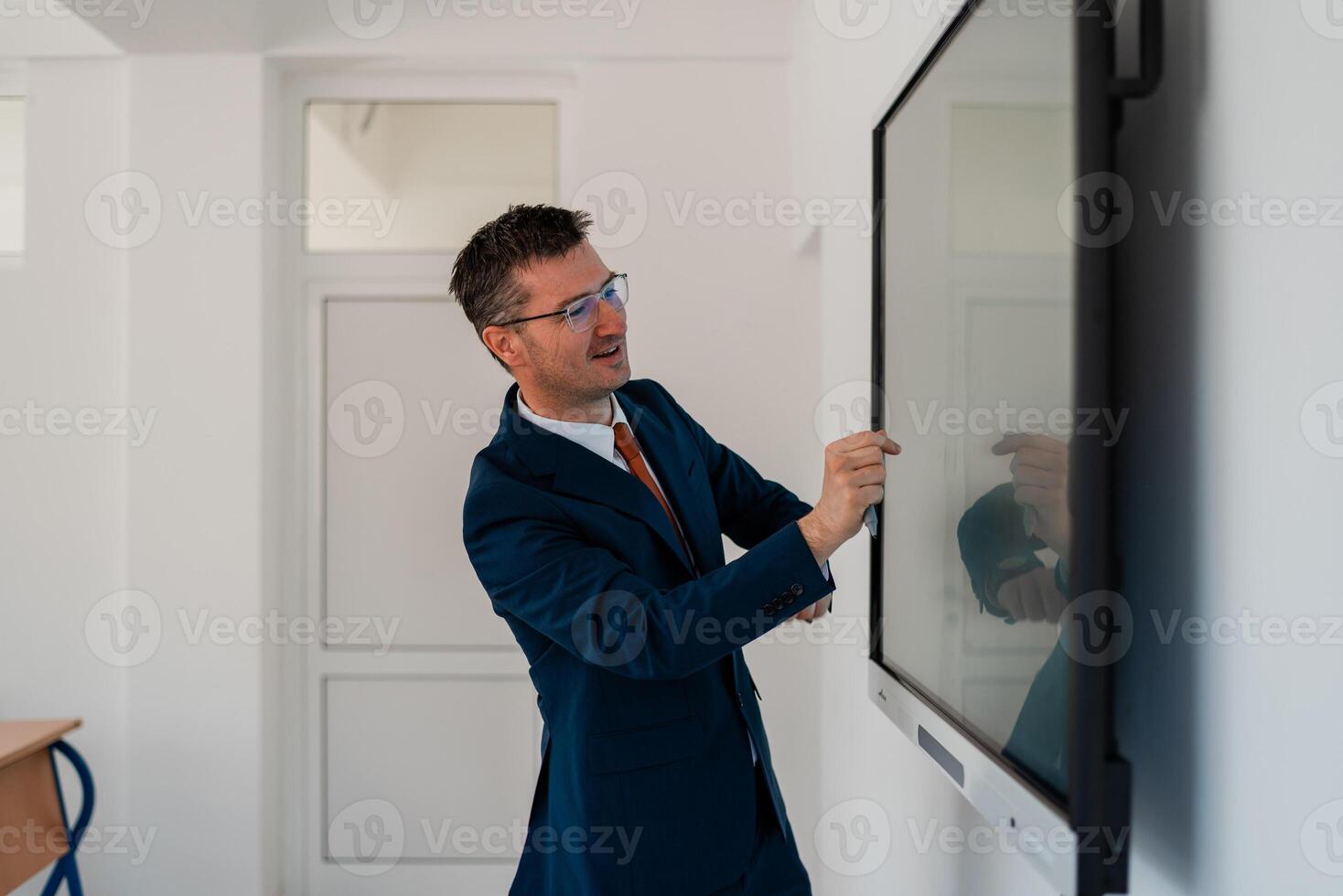 University male teacher giving lecture in the classroom or business man presenter public speaking in a conference meeting room using a display screen board. . photo
