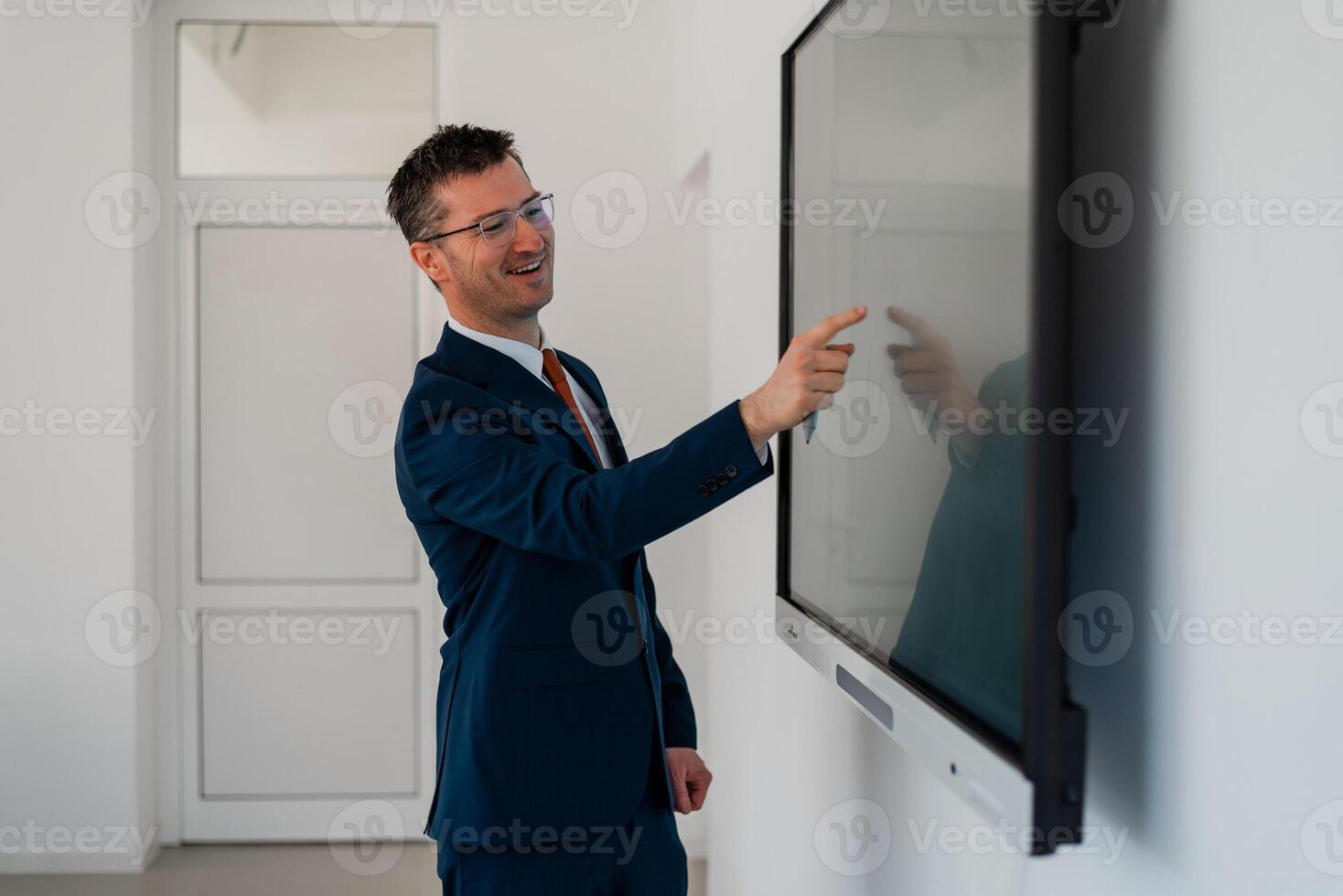 University male teacher giving a lecture in the classroom or a happy business man presenter public speaking about a working plan and strategy in a conference meeting room using a display screen board. photo