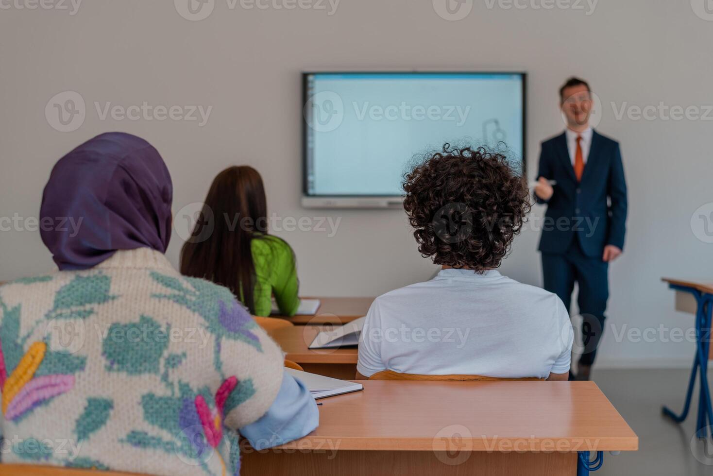 A university lecturer using a smart board to explain a lesson in the classroom. photo