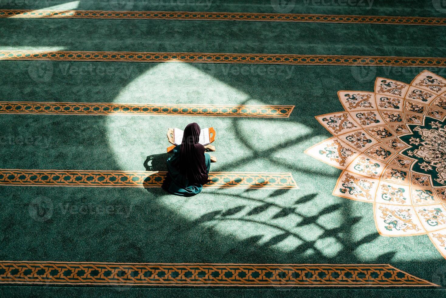 A Muslim woman praying inside the mosque. photo