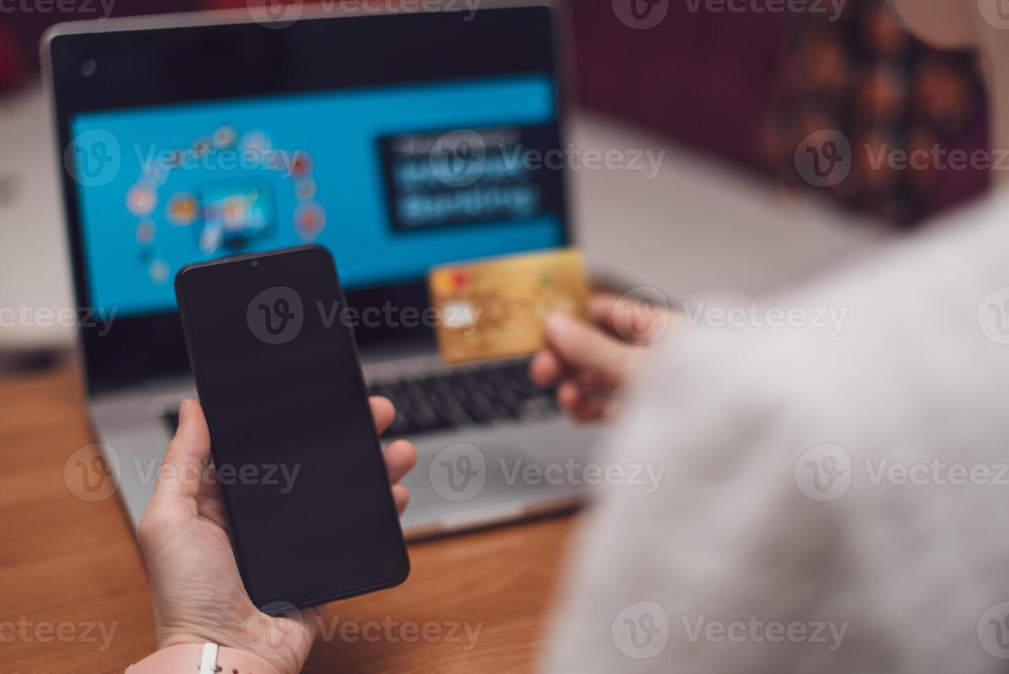 Female hands using mobile phone and holding credit card, Online Payment Internet Banking Concept. Woman using smartphone for online banking at home photo