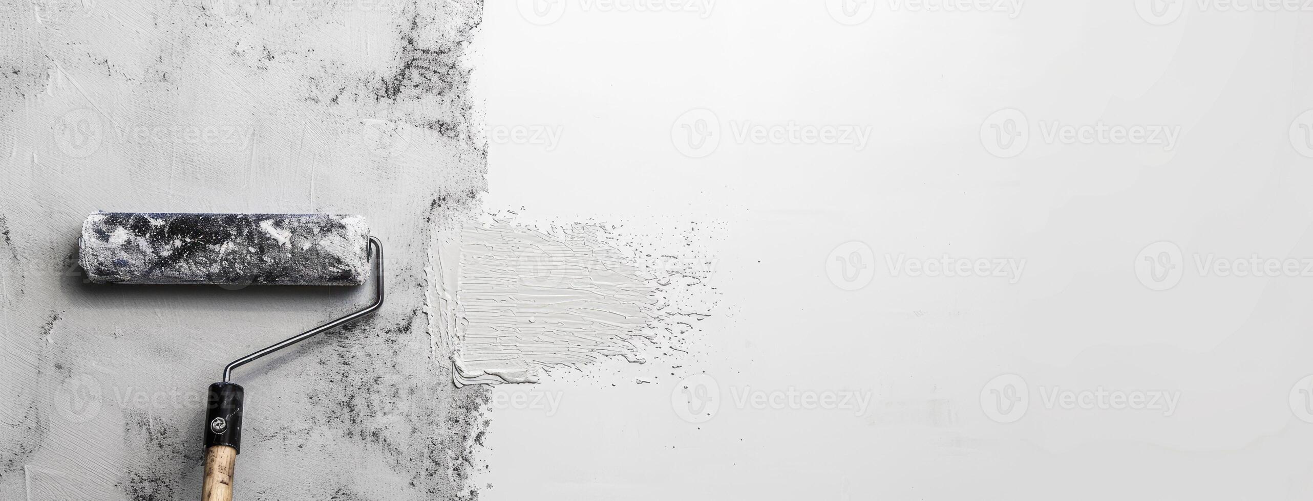 A paint roller is on top of a white wall photo