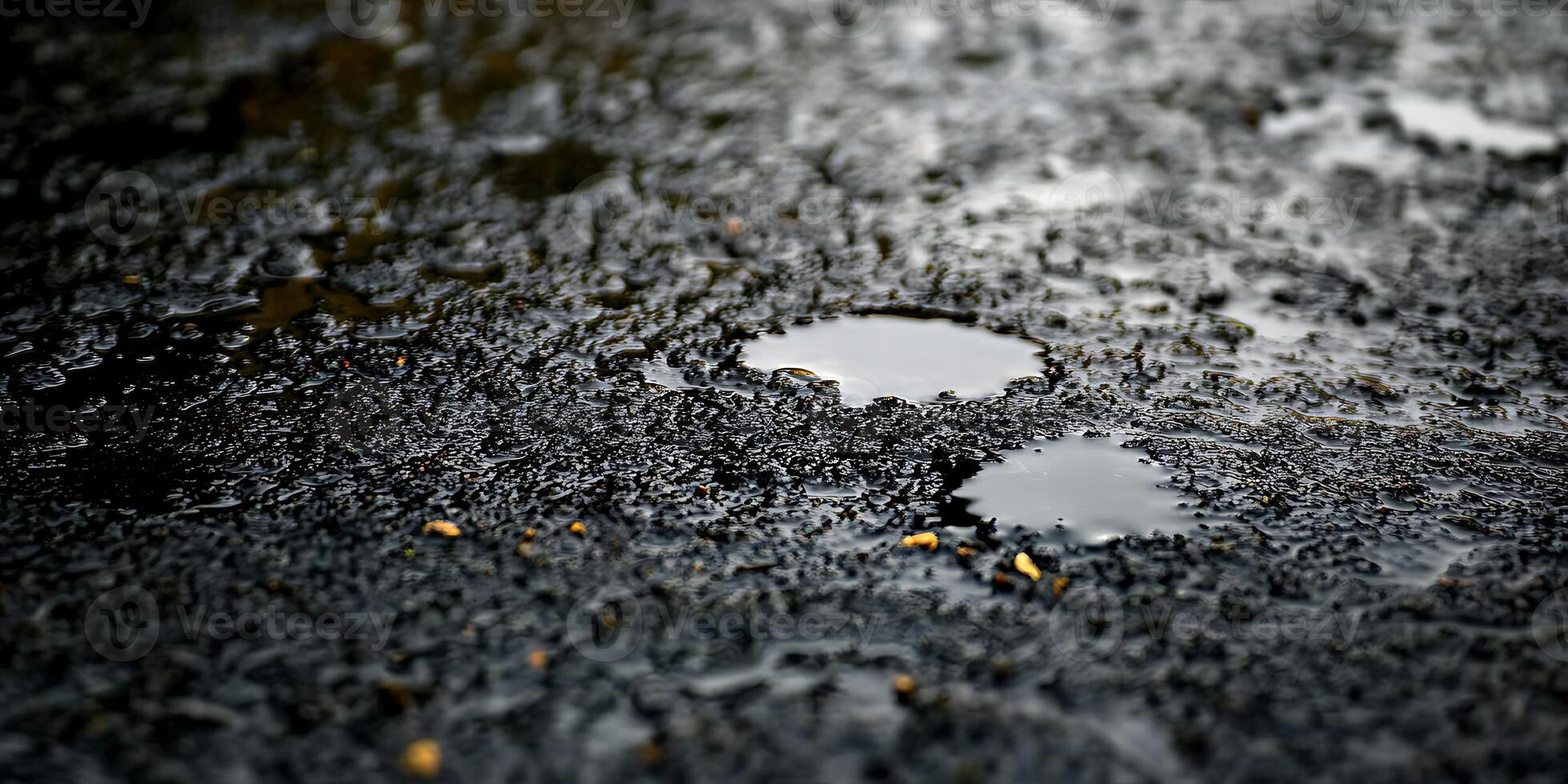 A puddle of water on the ground with a small hole in it photo