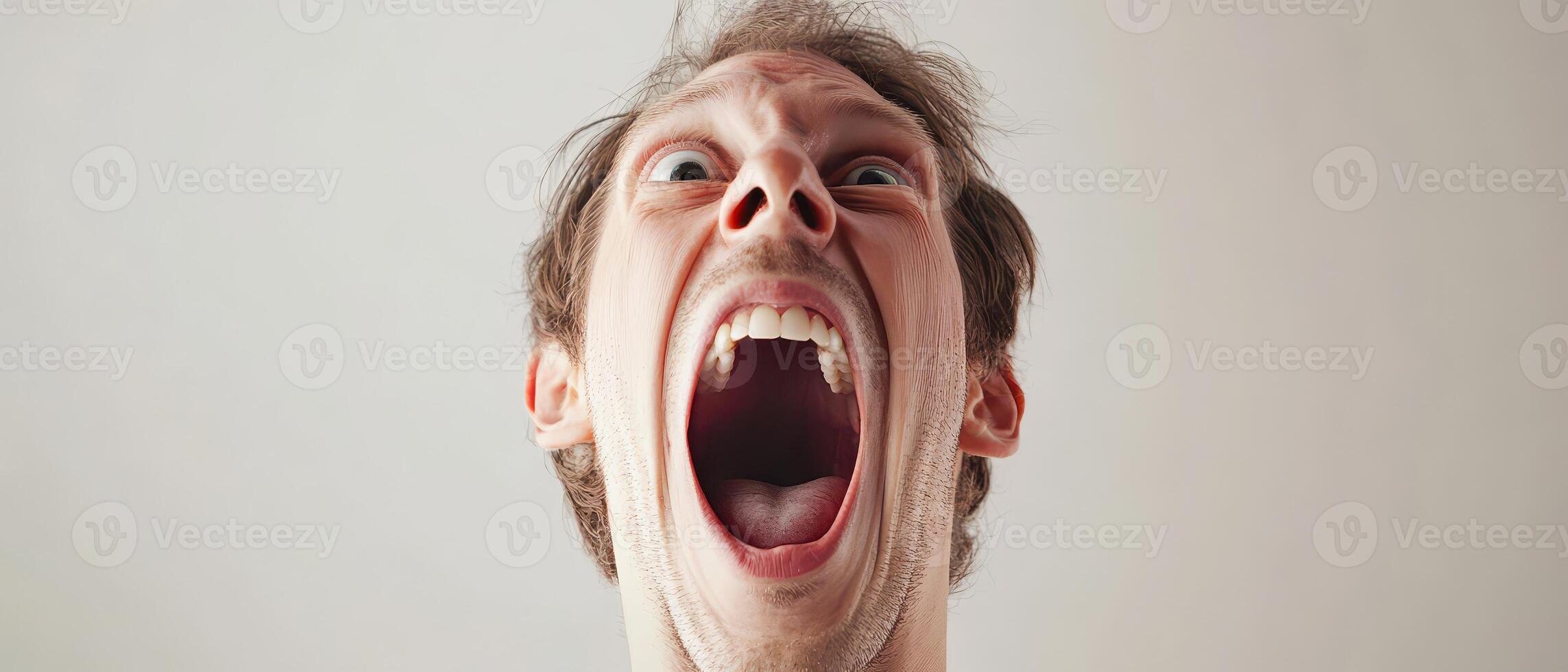 A man with his mouth open and his eyes wide photo