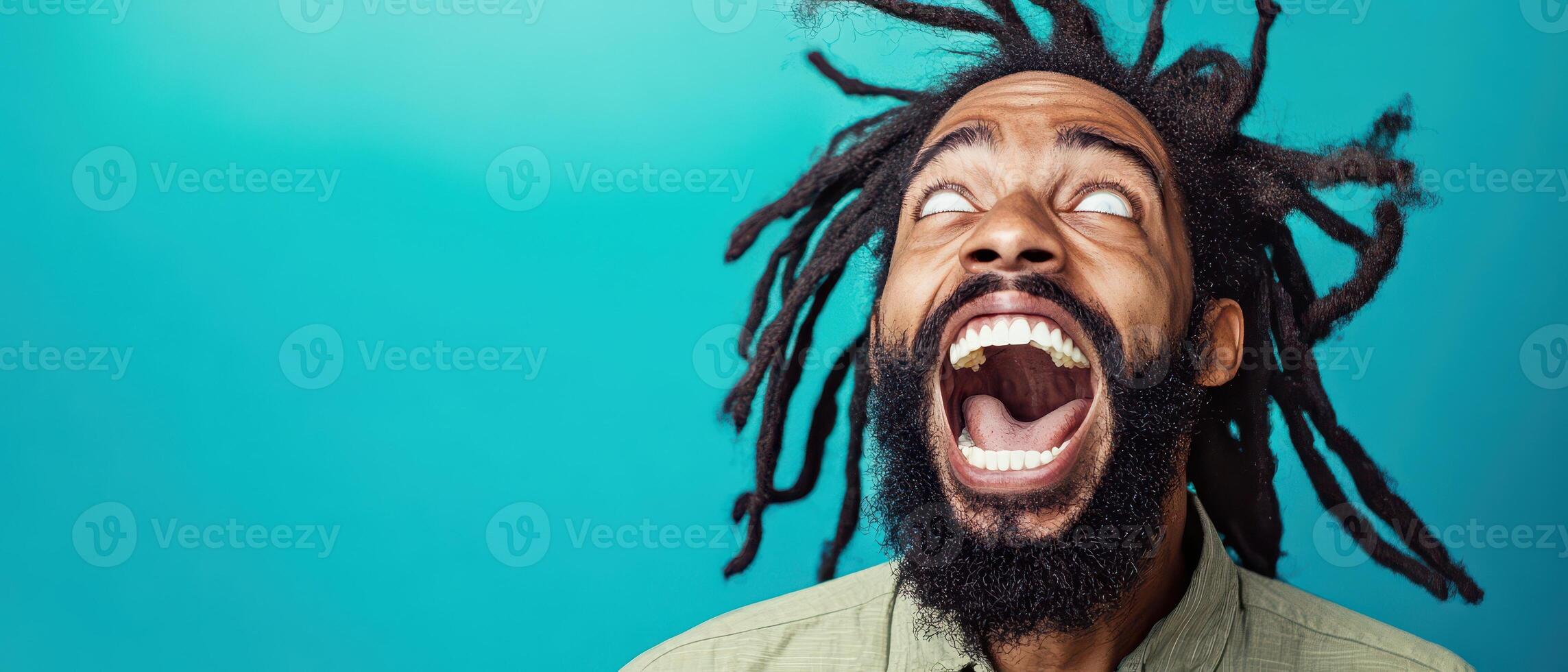 A man with dreadlocks is making a face photo