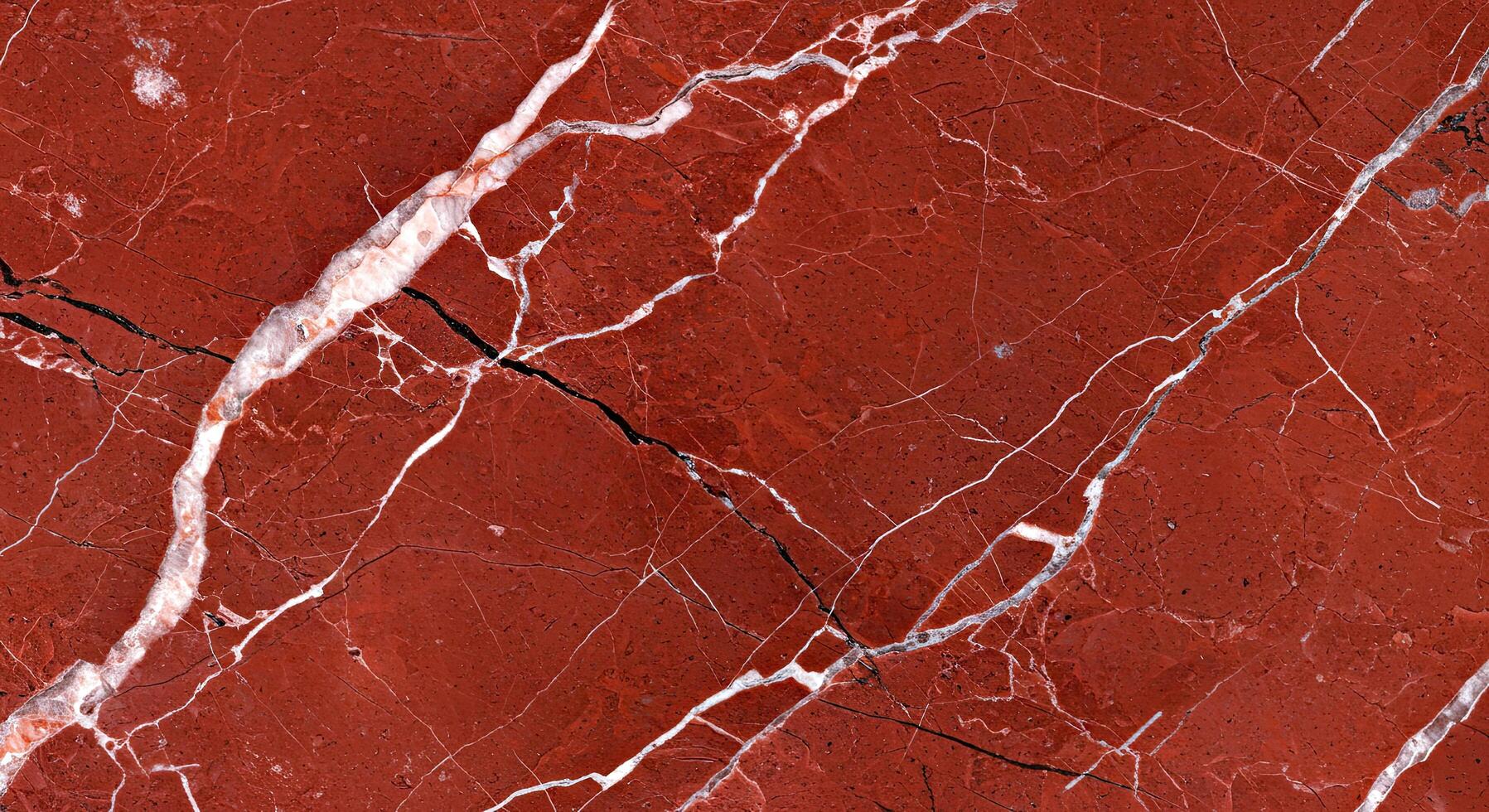 A close up of a red marble surface with white lines photo