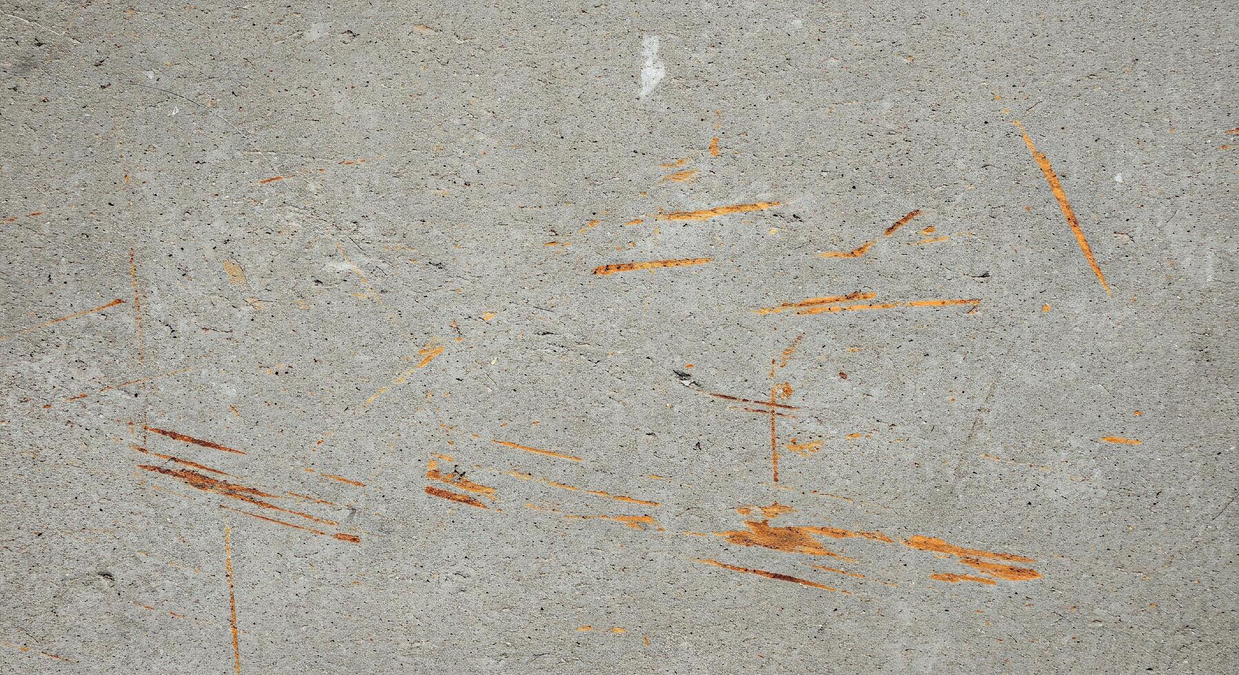 A concrete wall with orange paint on it photo