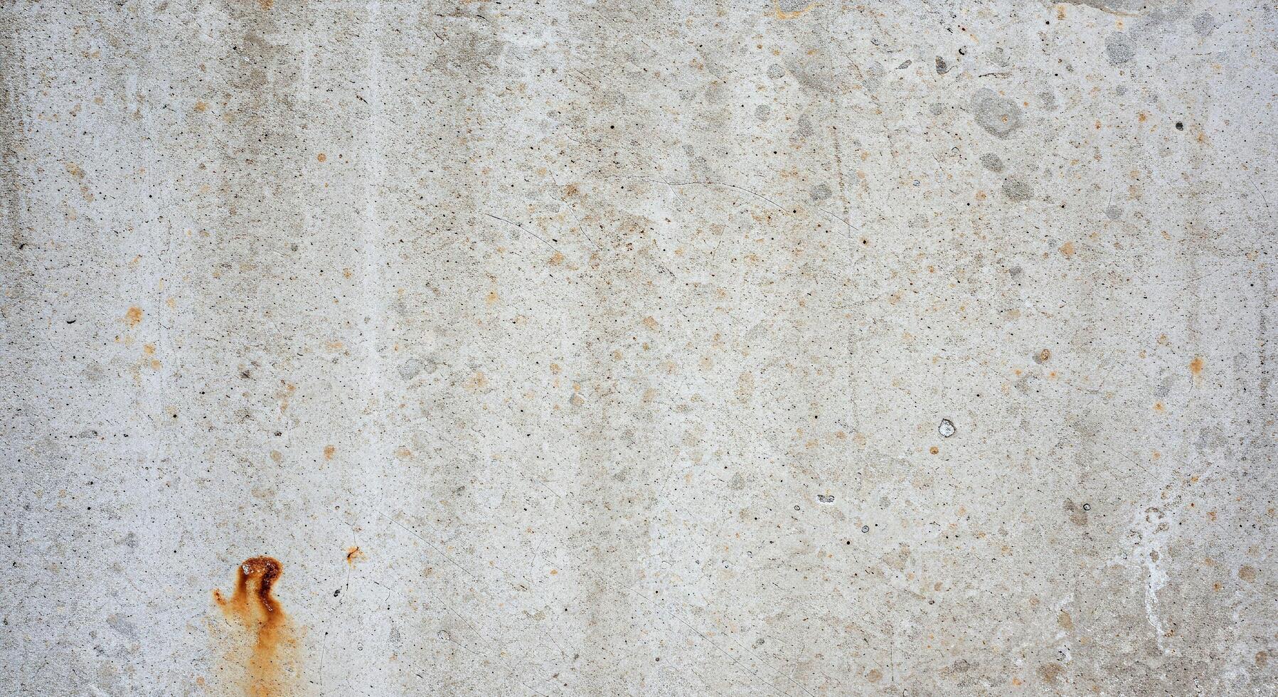 A red fire hydrant on a concrete wall photo