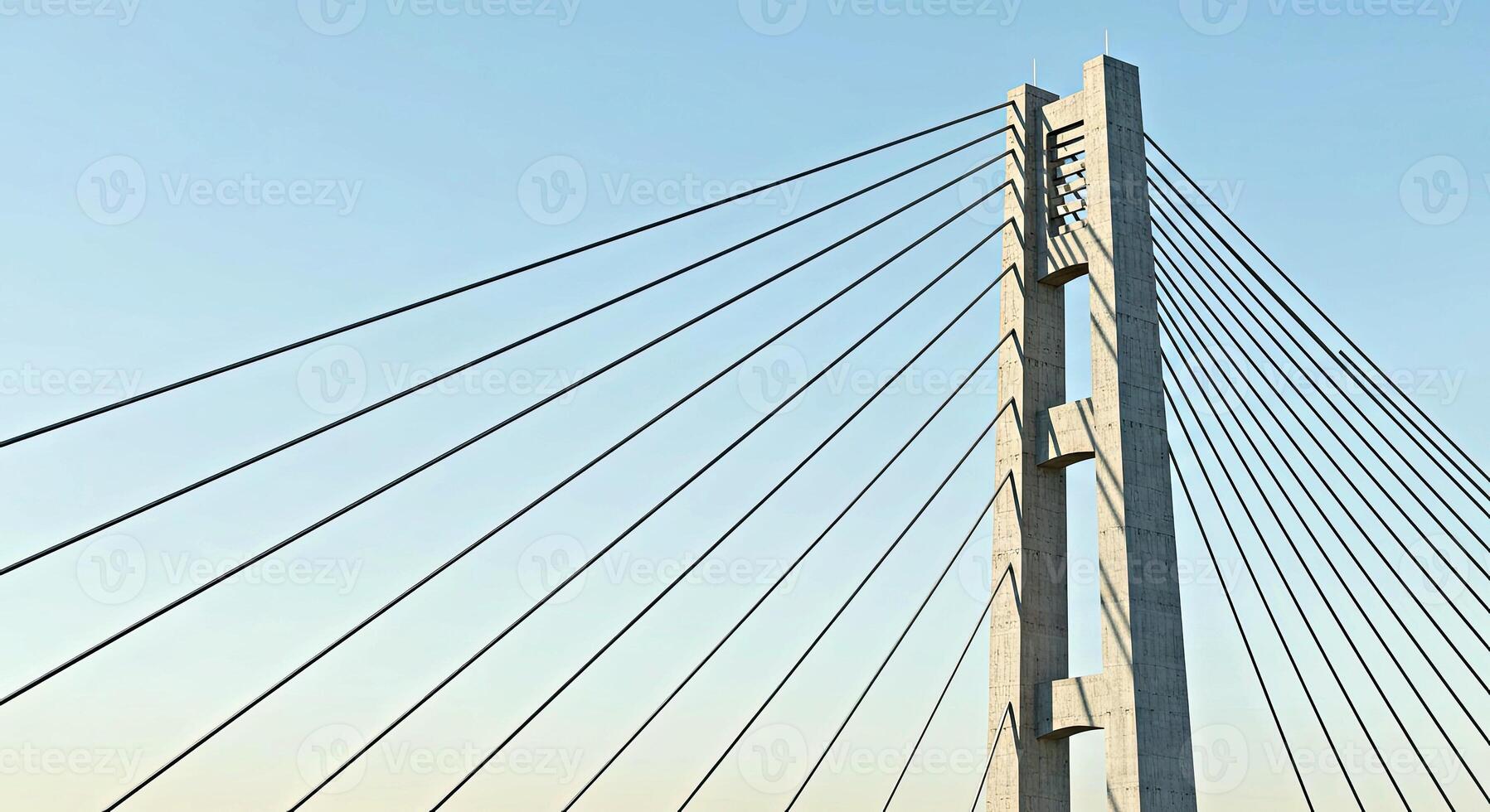 A bridge with many cables and a blue sky photo