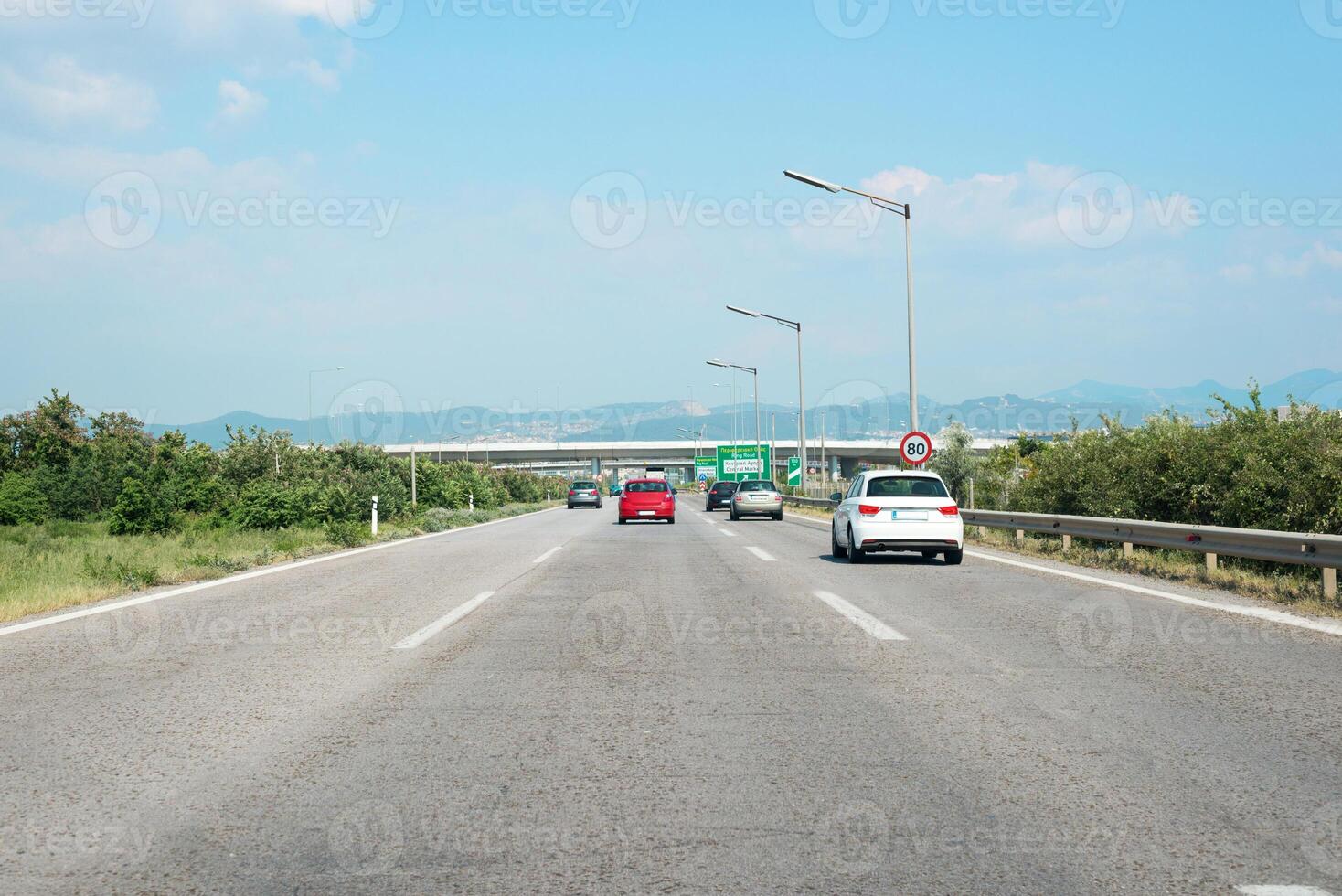 Driving along a highway with Mediterranean landscapes, capturing traffic flow and infrastructure, emphasizing transportation in Southern Europe photo