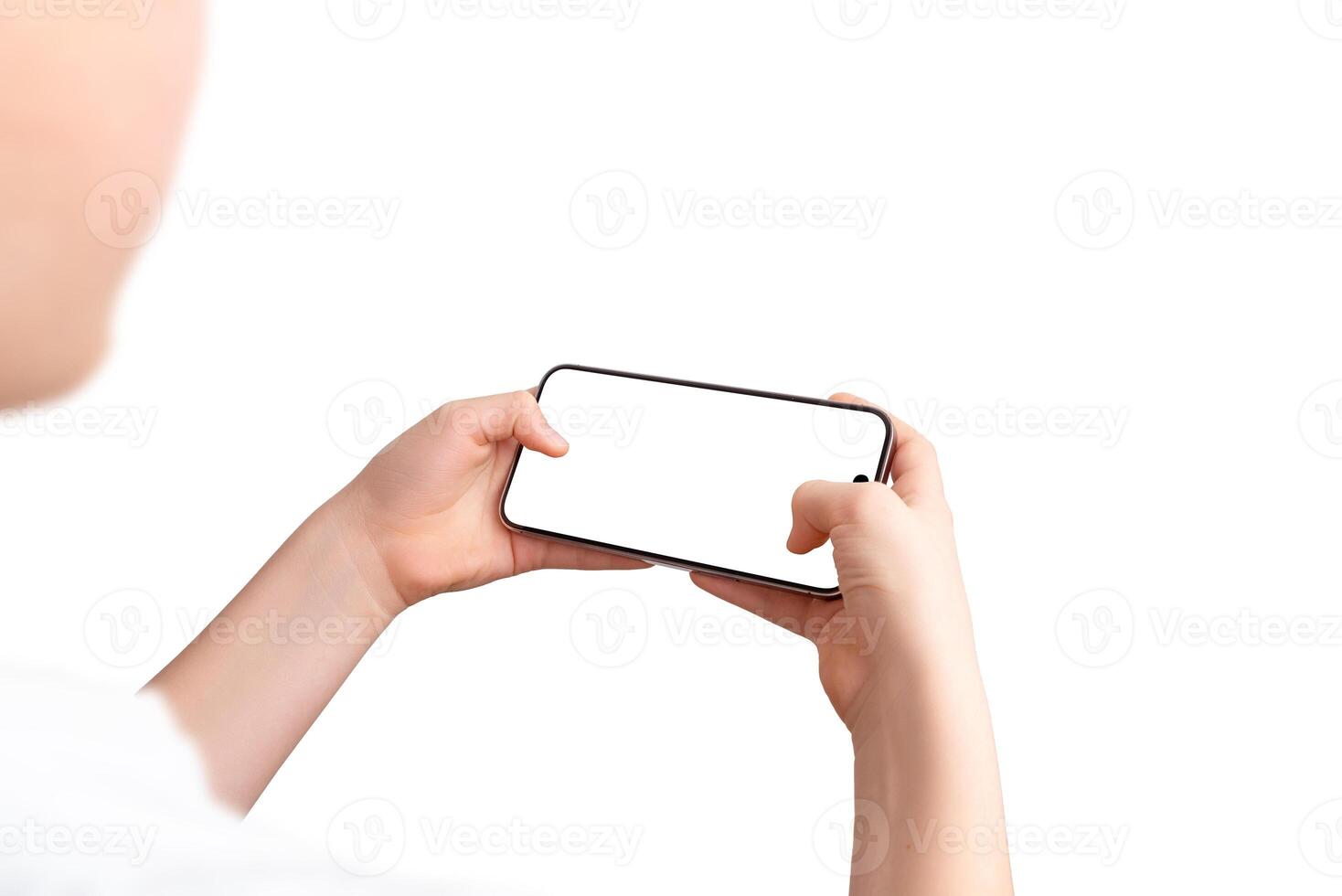 Boy holds a smartphone in a gaming position, using both thumbs on the screen. Over-the-shoulder view, isolated display and background, perfect for game promotion photo