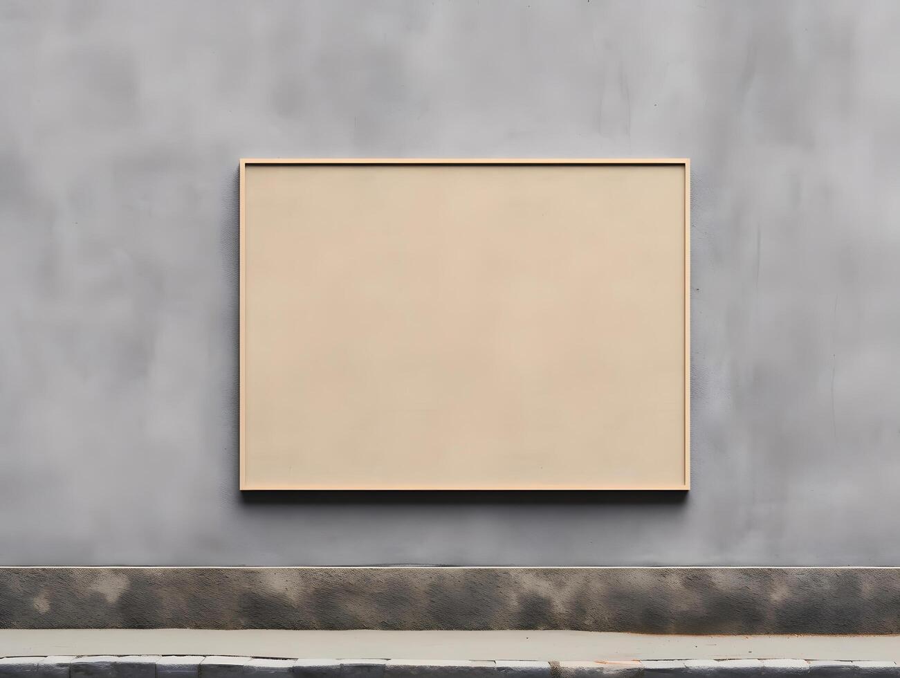 A square frame sitting on a wall in front of a gray wall photo
