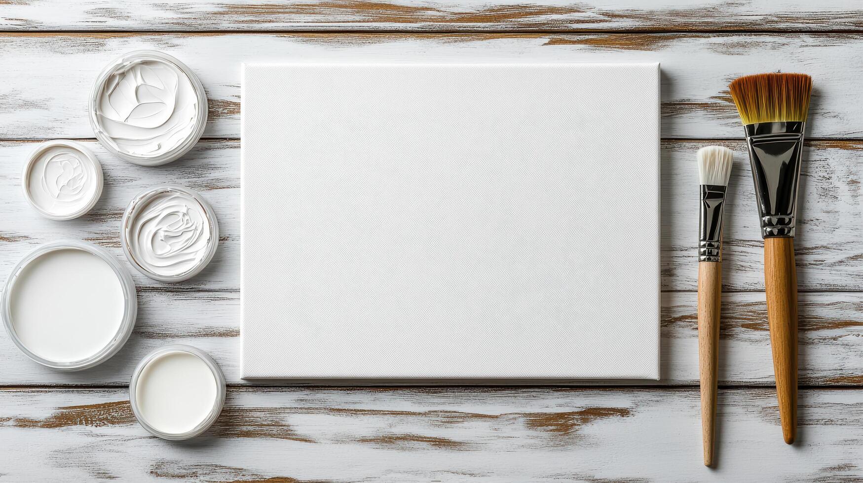 Blank canvas with brushes and paint jars ready for creativity photo