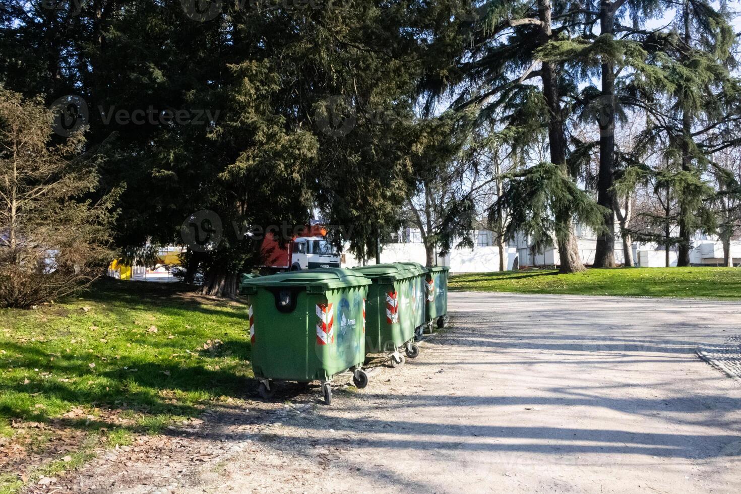 green color garbage cans in the park on the background of the forest photo