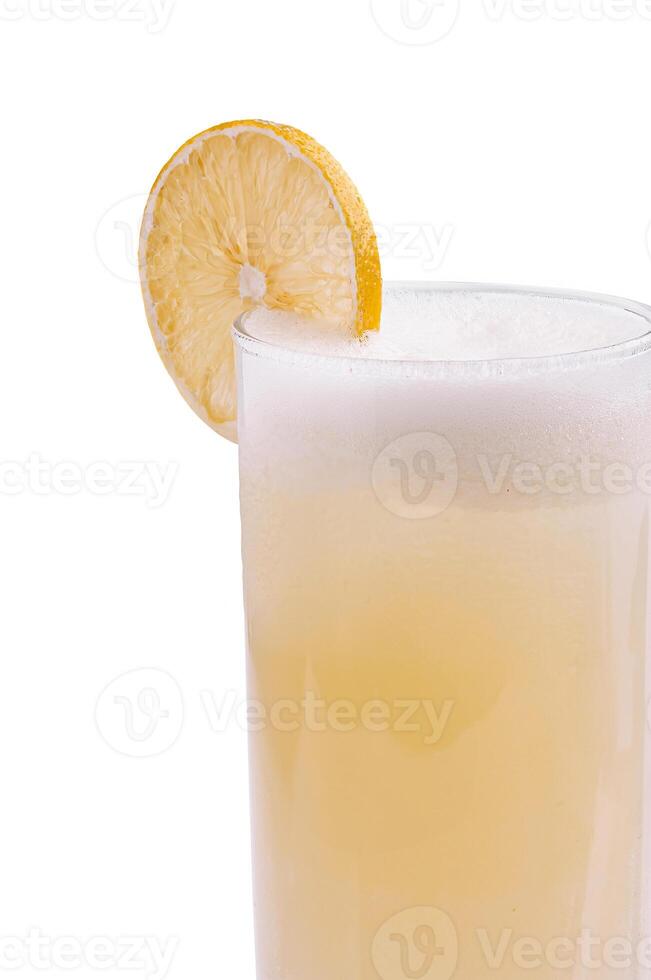 Refreshing beverage with lemon slice in tall glass photo