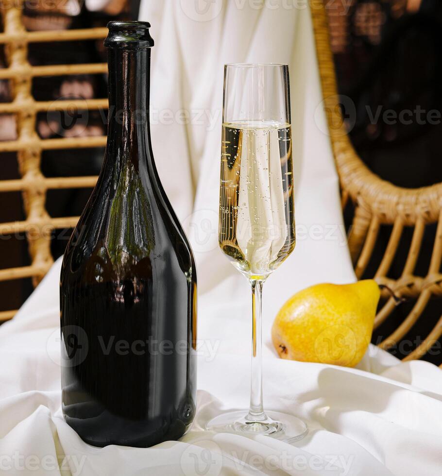 Sparkling drink and pear on soft white fabric settings photo