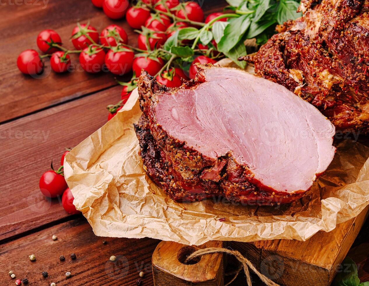 Deliciously prepared sliced meat with fresh tomatoes on wooden table photo