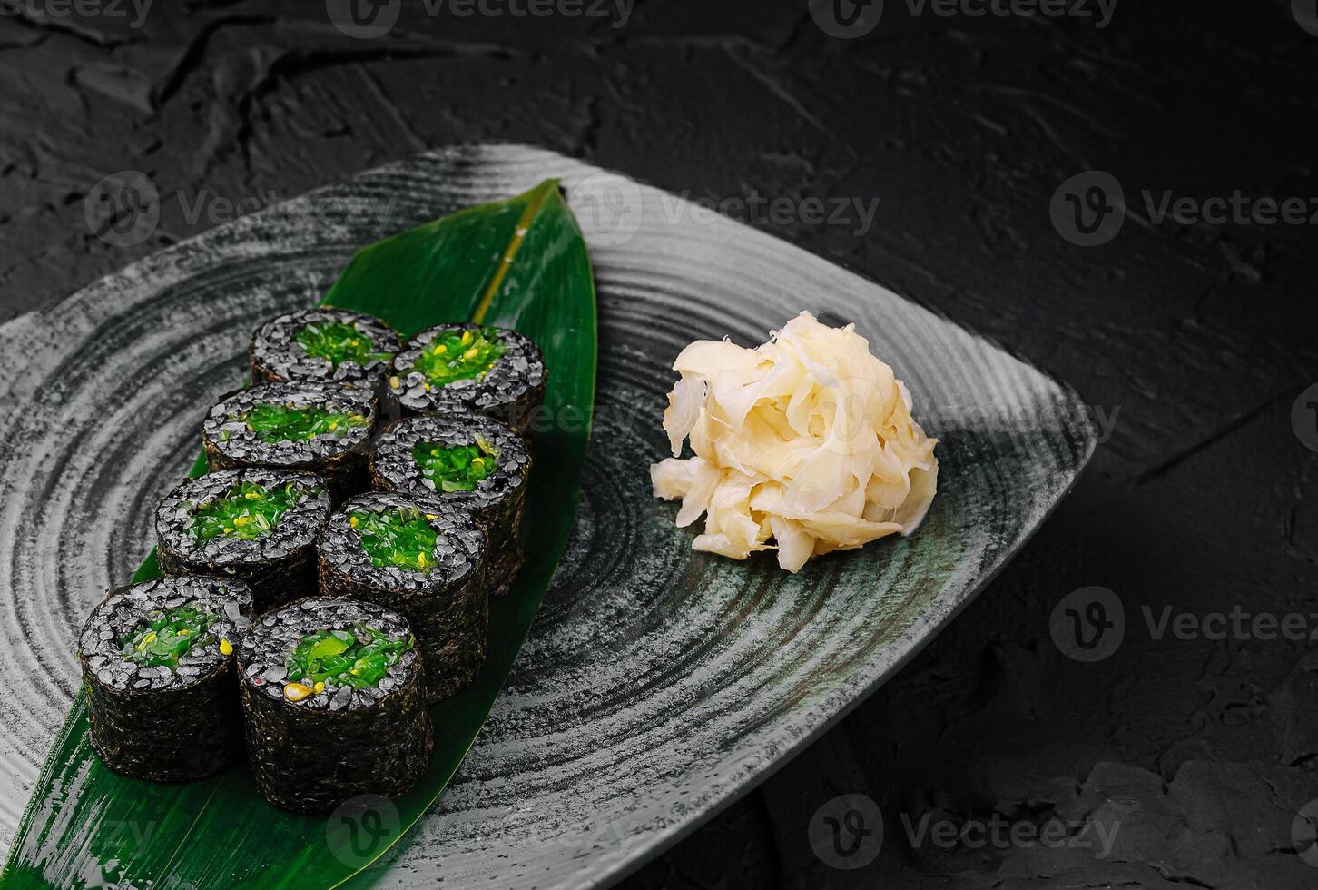 Freshly prepared sushi rolls served on a decorative plate photo