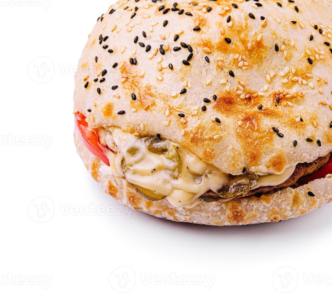 Delicious sandwich with sesame seed bun and fresh ingredients photo