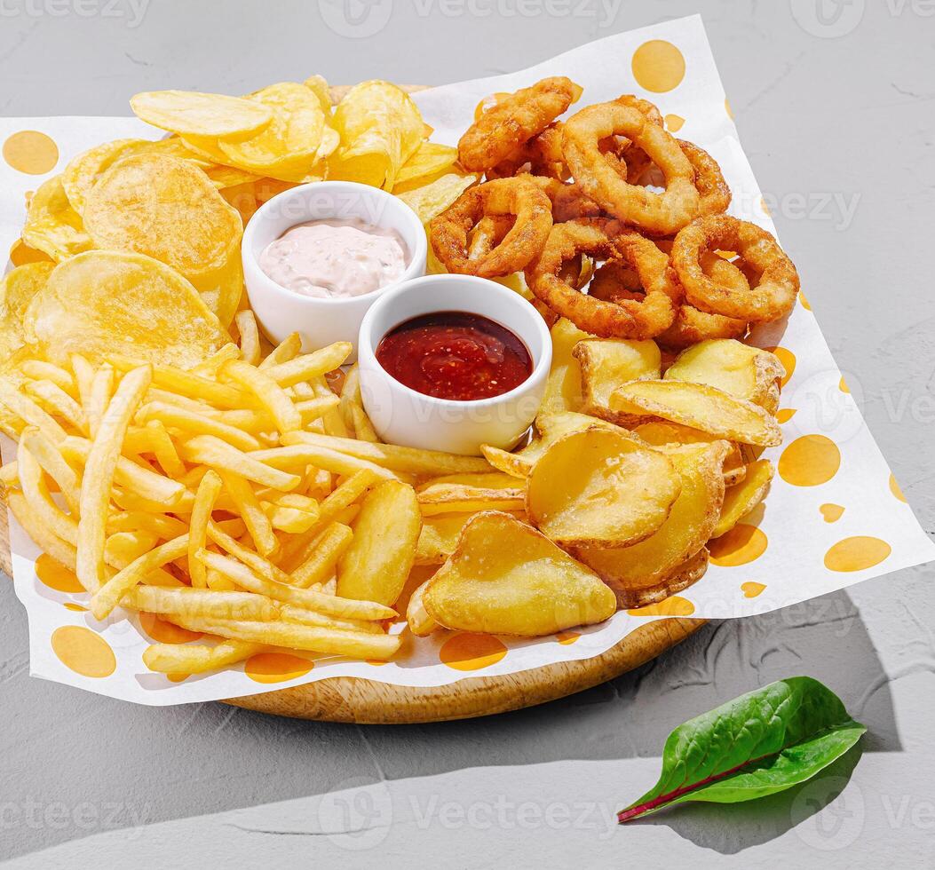 Tasty platter of appetizers with dips and crunchy snacks photo