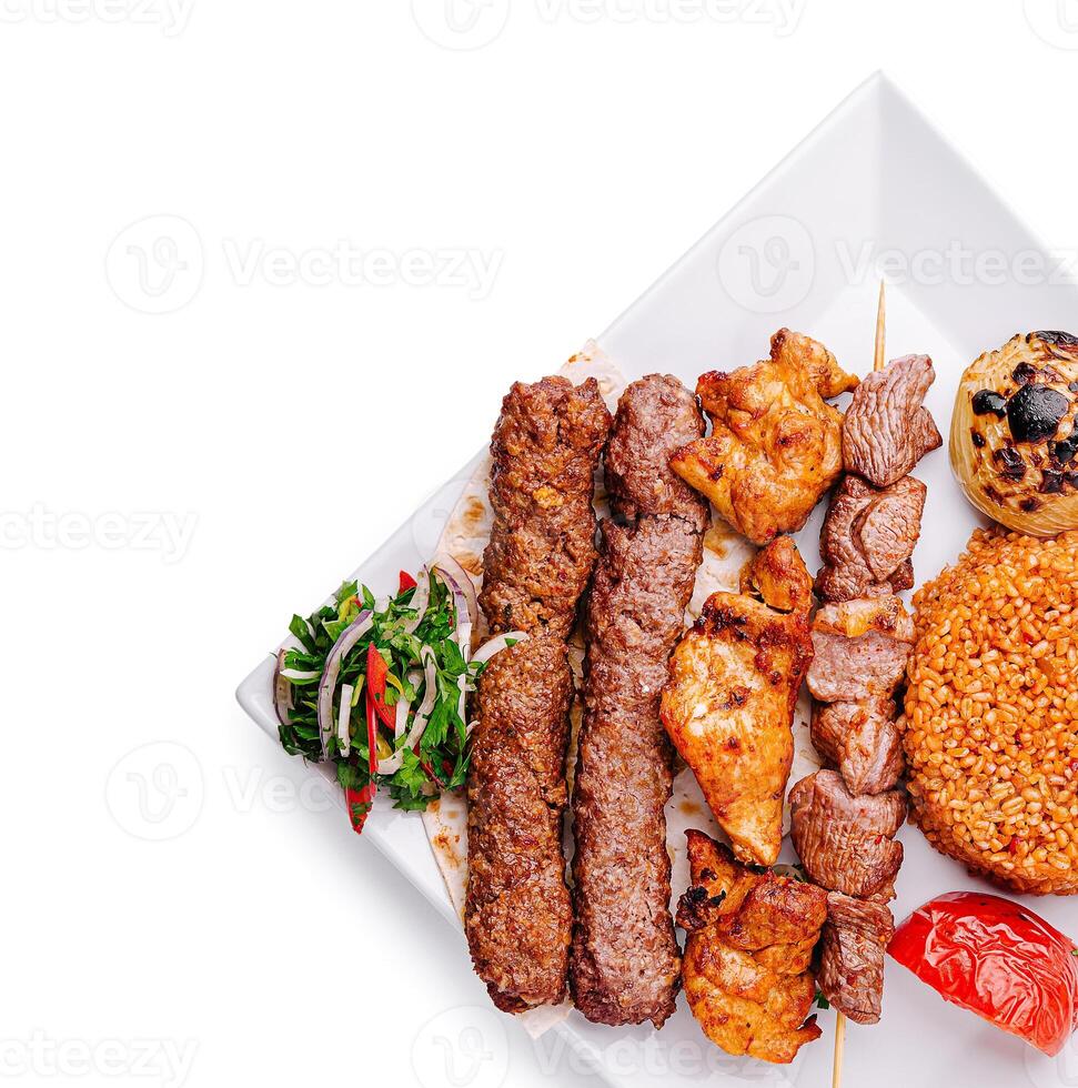 Grilled meat platter with rice and fresh vegetables for dinner photo