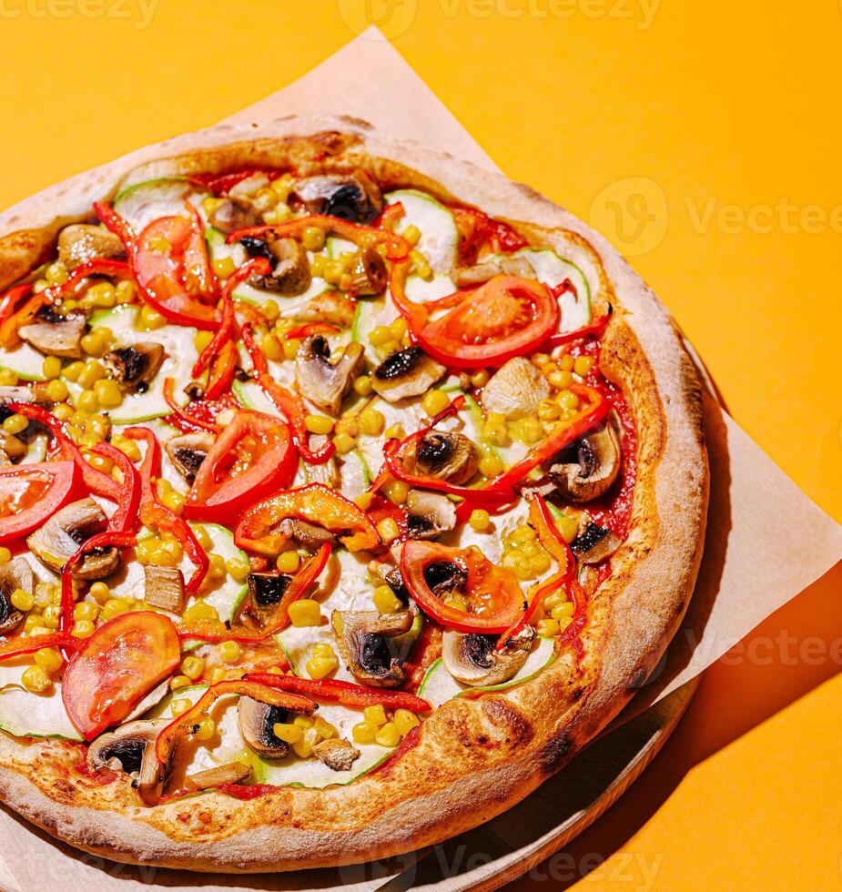 Delicious vegetarian pizza with vibrant toppings on bright background photo