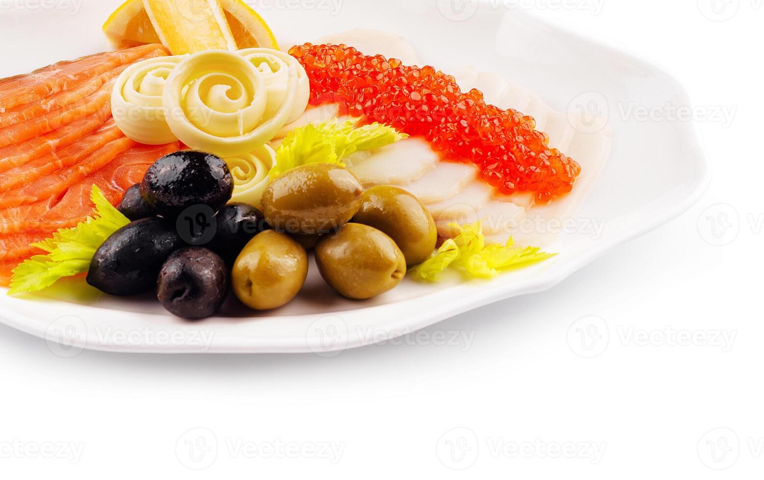 Elegant plate of smoked salmon, red caviar, olives, and lemon garnish photo