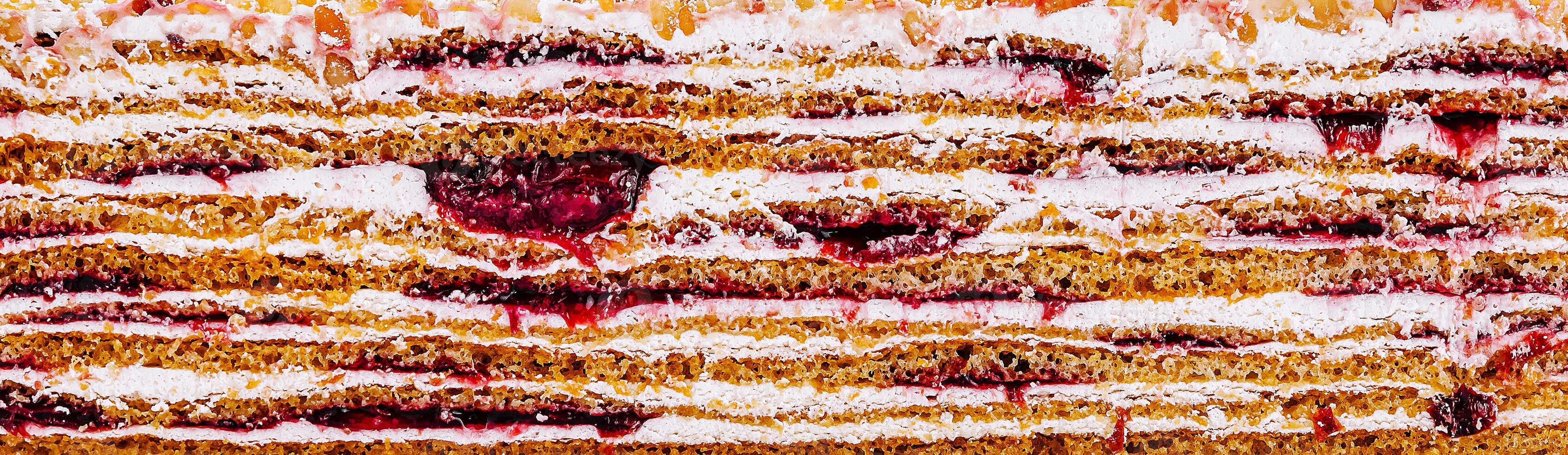 Delicious layers of cake with berry filling and cream icing photo