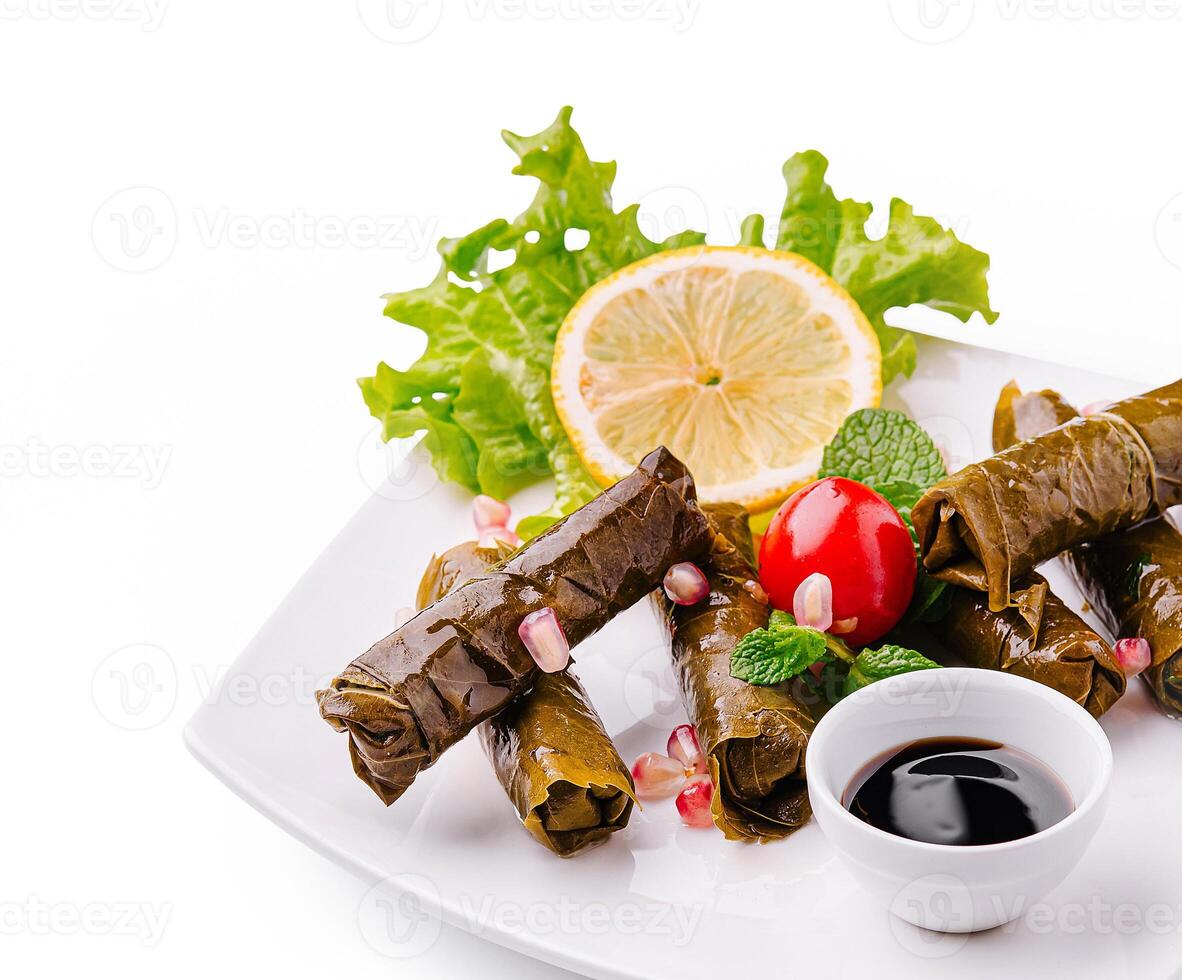 Delicious dolma served with fresh greens and garnishes photo