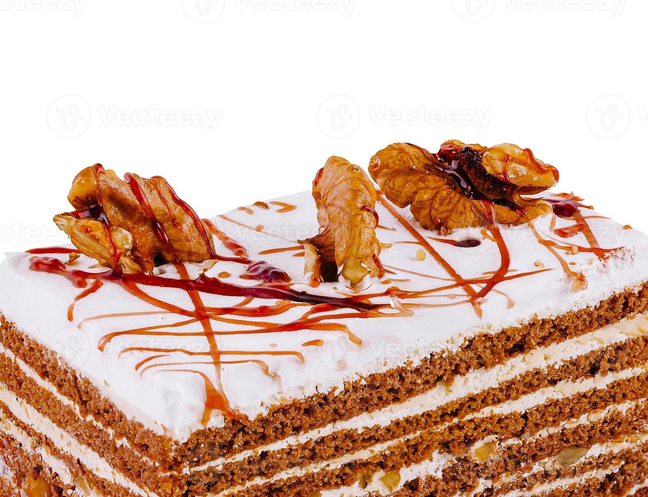 Delicious cake with walnuts and caramel drizzle on white background photo
