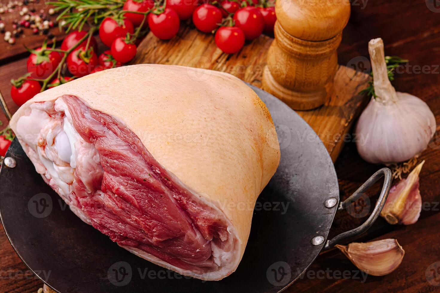 Fresh meat preparation at a rustic kitchen table with herbs photo