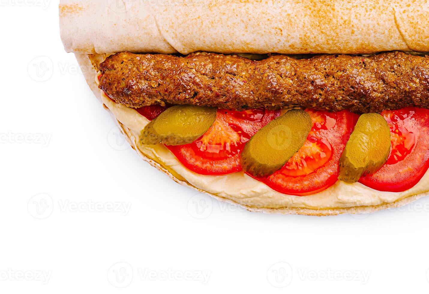 Delicious wrap filled with grilled meat and fresh vegetables photo