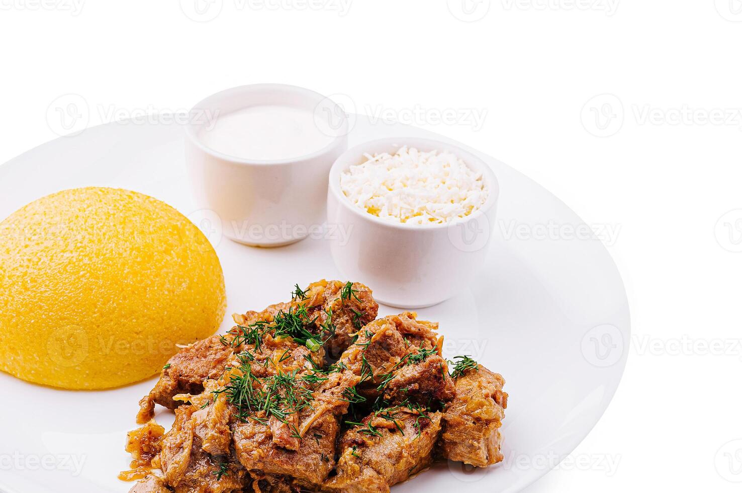 Savory meat dish served with rice and creamy sauce on white plate photo