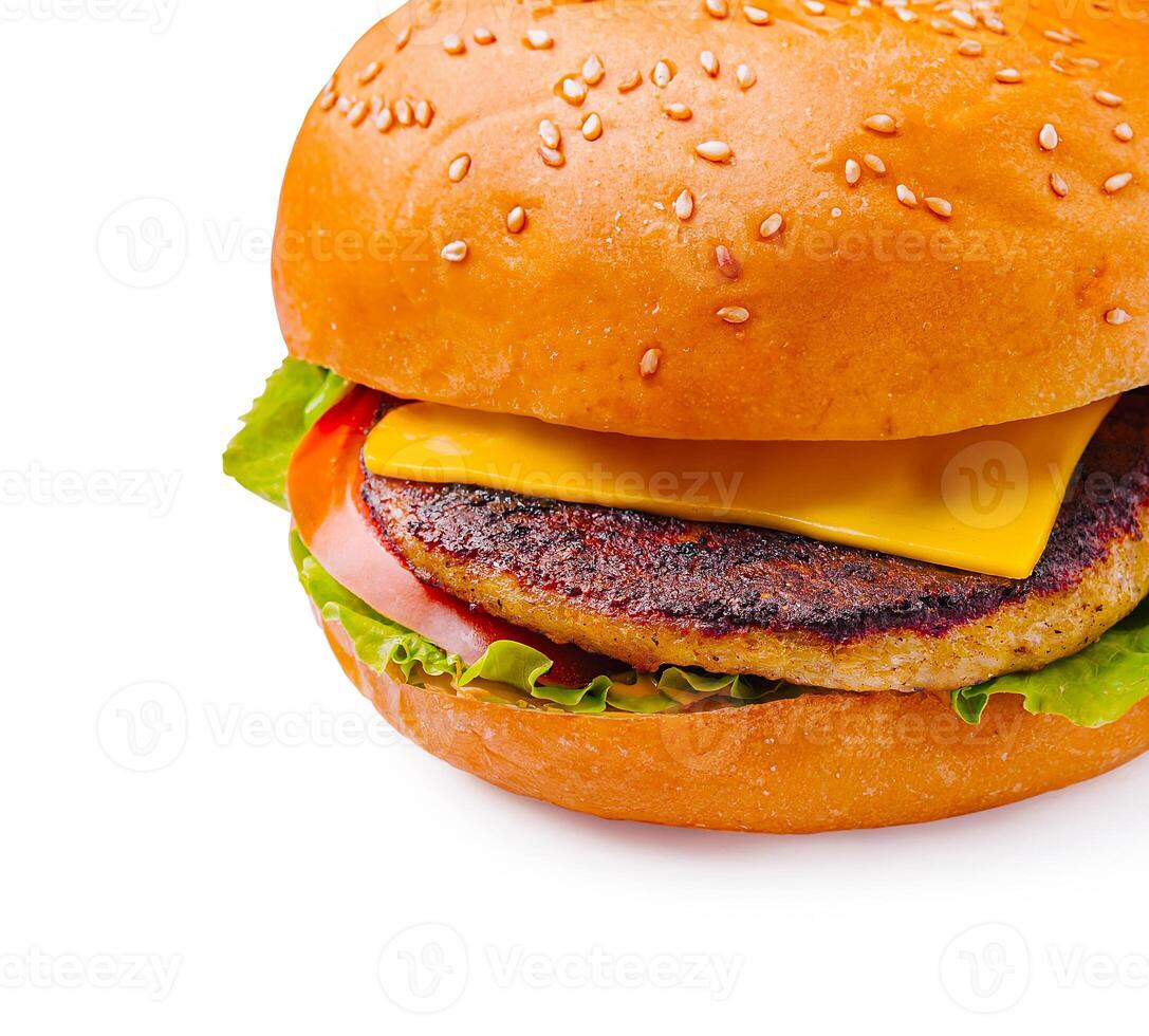 Juicy cheeseburger with fresh vegetables on sesame bun photo